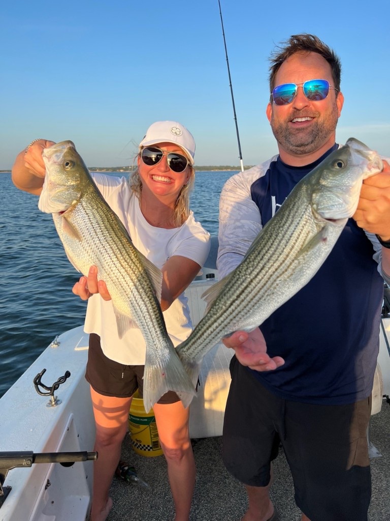 Smiling couple holding their catch on a Lake Texoma fishing trip